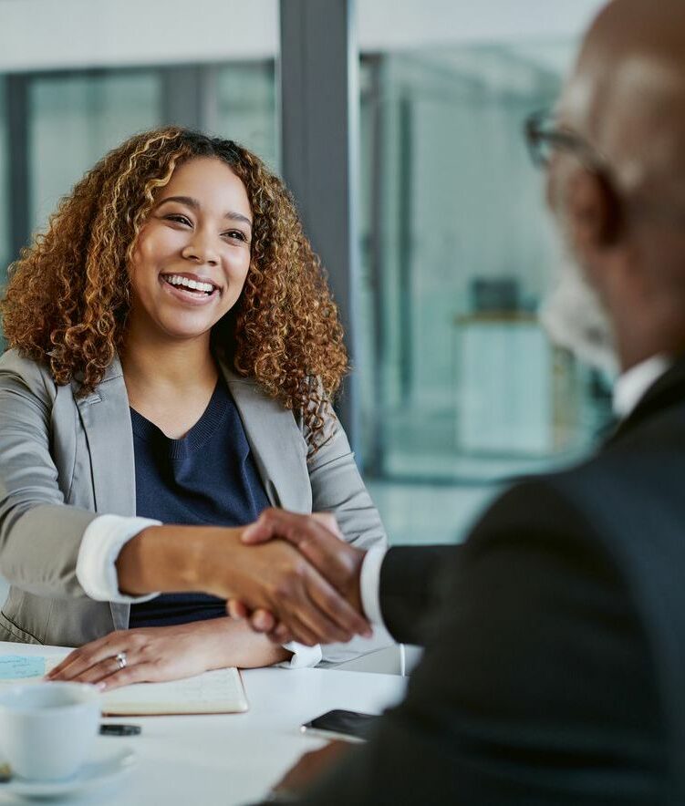 Shot of two businesspeople shaking hands in an office